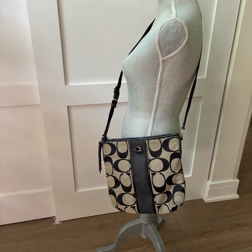 Coach Chic Black and Cream Crossbody Bag with Modern Design and expendable strap